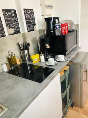 a kitchen counter top with a coffee maker on it at Studio Douillet Hypercentre 12 min de Paris in Enghien-les-Bains