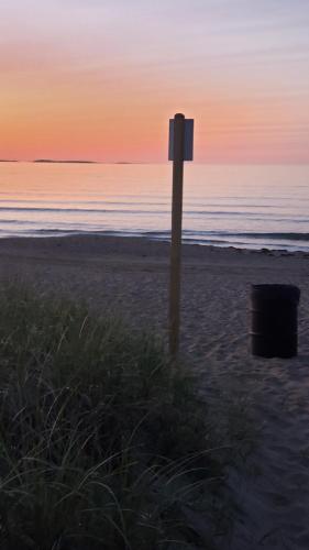 a sign on the beach at sunset at White Cap Village Unit 6 in Old Orchard Beach