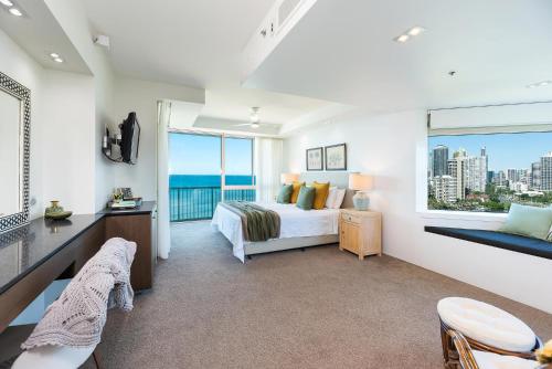 a bedroom with a bed and a large window at The Waterford on Main Beach in Gold Coast