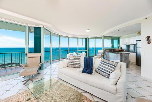 a living room with a couch and views of the ocean at The Waterford on Main Beach in Gold Coast