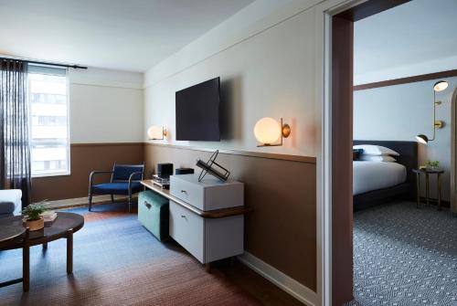 a hotel room with a bed and a desk at Kimpton Saint George Hotel by IHG in Toronto
