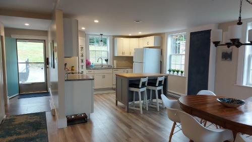 a kitchen with a table and a kitchen with a dining room at Cozy Harbour House in Isaacs Harbour