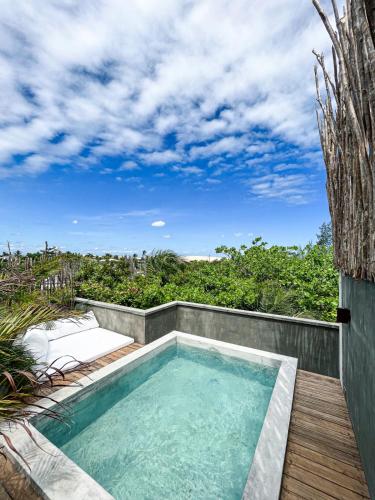 a small swimming pool on a deck next to avisor at Villa Mango Jeri in Jericoacoara