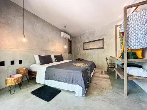 a bedroom with a bed and a ladder in it at Villa Mango Jeri in Jericoacoara