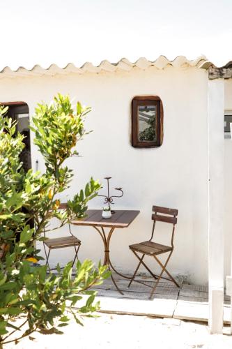 a table and two chairs on a patio at Salty House Cabo Polonio in Cabo Polonio