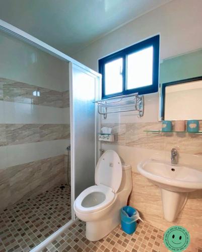 a bathroom with a toilet and a sink at 蘑菇村-童心未泯民宿 in Taitung City