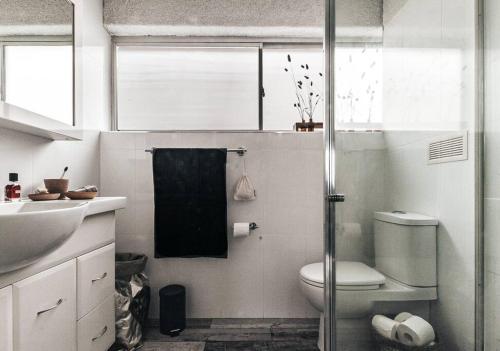 a bathroom with a toilet and a sink at Bay Properties Pacific Sun in Yamba