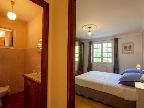 a bedroom with a bed and a sink and a mirror at Maison de charme avec piscine privée, salle de sport proche de Bergerac et Périgueux - FR-1-616-132 in Villamblard