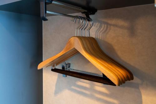 a wooden towel rack hanging on a wall at Premier Hotel Mojiko in Kitakyushu