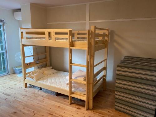 a room with two bunk beds in a room at Rokko Outdoor Station FOTON in Kobe