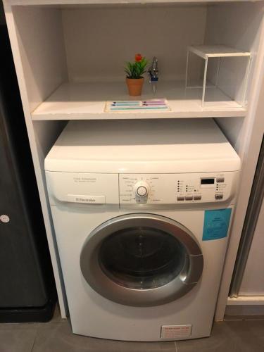 a washing machine with a shelf on top of it at City Home Suites Kuala Lumpur City Centre in Kuala Lumpur