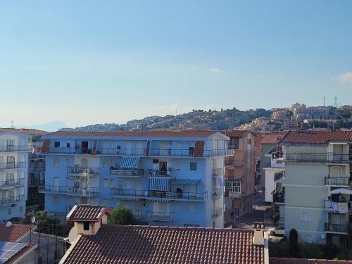 a group of buildings in a city with mountains in the background at Stunning views, 2-Bed Apartment in Scalea in Scalea