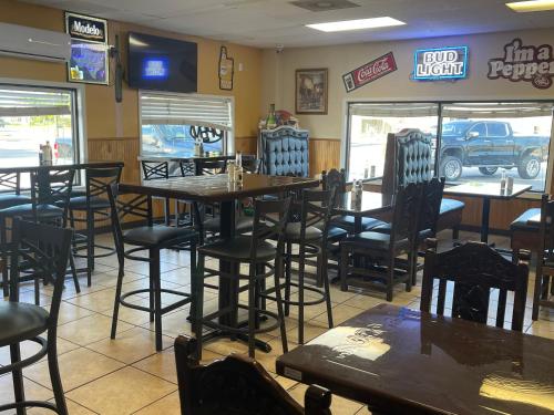 a dining room with tables and chairs in a restaurant at Lufkin Inn in Lufkin