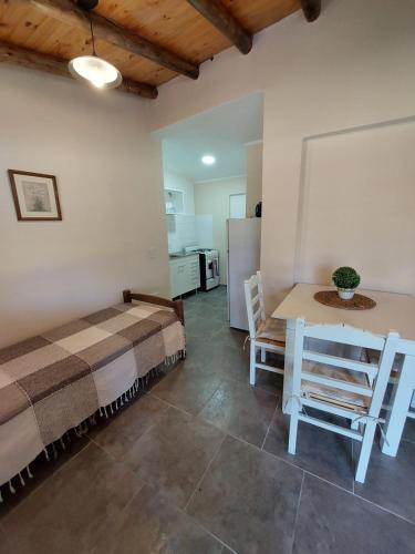 una habitación con una cama, una mesa y sillas en Cabañas Casa fuerte, en San Rafael