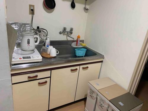 a kitchen counter with a sink and a stove at Jinpachi Building - Vacation STAY 63997v in Gifu