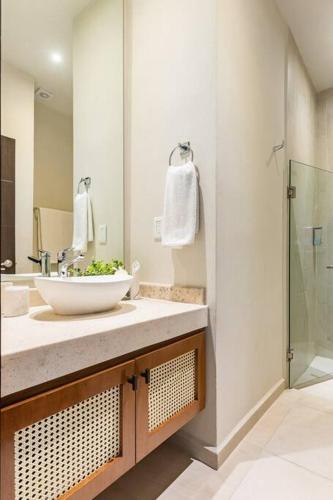 a bathroom with a sink and a shower at Aqua in Playa del Carmen
