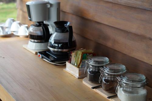 a counter with jars of food and a coffee maker at Natuna Dive Resort in Ranai