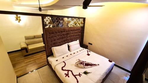 a bedroom with a bed with red decorations on it at MMD Grande A Boutique Hotel in Thanjāvūr