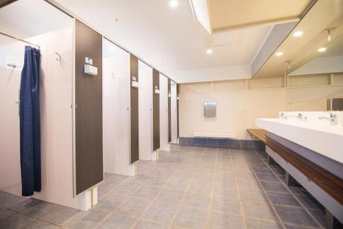 a bathroom with a row of sinks and mirrors at Hastings TOP 10 Holiday Park in Hastings