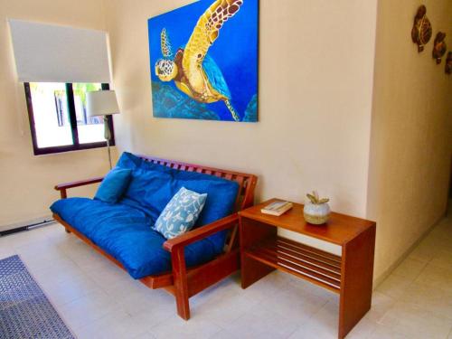 a living room with a blue couch and a table at Two bedroom beachfront villa Celestun in Celestún