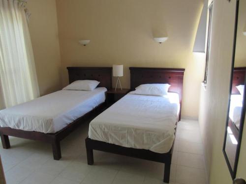 a hotel room with two beds and a window at Two bedroom beachfront villa Celestun in Celestún