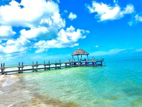 a pier in the water with people on it at Two bedroom beachfront villa Celestun in Celestún