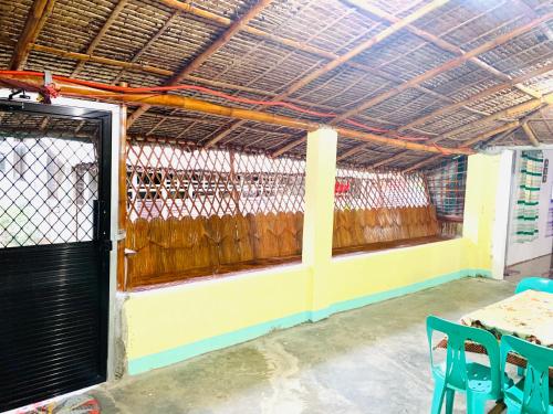 a room with a fence and a wooden door at VILLA ROUCHELE KIKAY Resthouse Vacation HOME in San Ildefonso