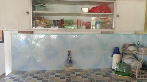 a kitchen with a sink and a cabinet with food at VILLA ROUCHELE KIKAY Resthouse Vacation HOME in San Ildefonso