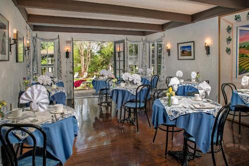 a dining room with blue tables and chairs at Candlelight Inn Napa Valley in Napa