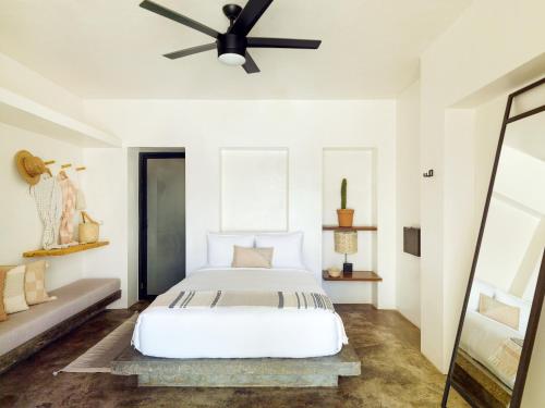 a bedroom with a bed and a ceiling fan at Drift San Jose del Cabo, a Member of Design Hotels in San José del Cabo