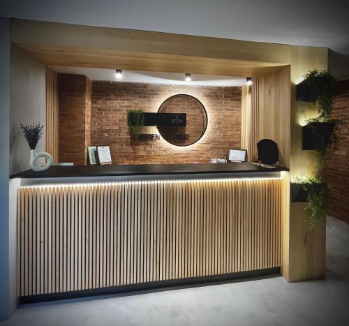 a lobby with a reception desk with a brick wall at Garden Retreat Junior in Bran
