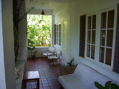 a living room with a couch and a window at Green Roof Inn in Carriacou