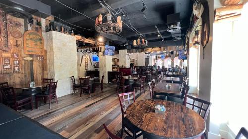 a dining room with a wooden table and chairs at The Crockett Hotel in San Antonio