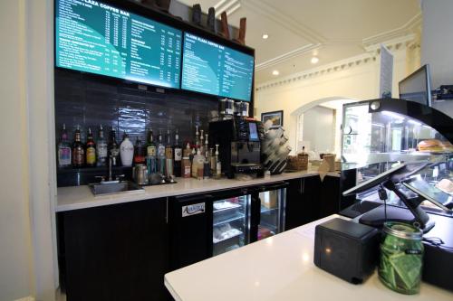 a bar with a counter with a lot of bottles at The Crockett Hotel in San Antonio
