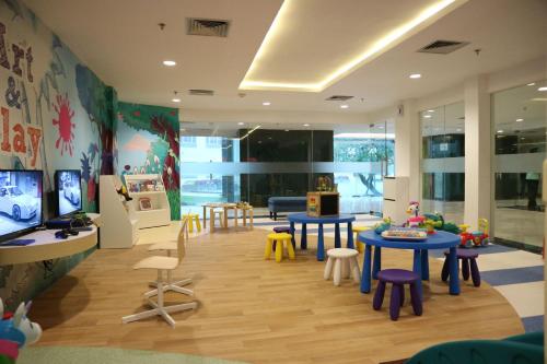 a childrens room with tables and chairs and a tv at Aston Tanjung Pinang Hotel & Conference Center in Tanjung Pinang 