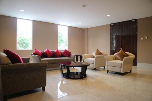 a waiting room with couches and chairs and a table at Aston Tanjung Pinang Hotel & Conference Center in Tanjung Pinang 
