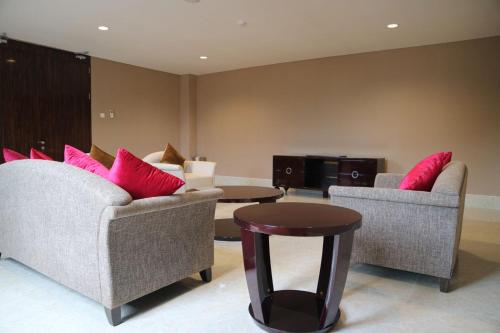 a living room with two chairs and a table at Aston Tanjung Pinang Hotel & Conference Center in Tanjung Pinang 