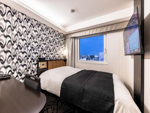 En eller flere senge i et værelse på APA Hotel Ueno Ekiminami