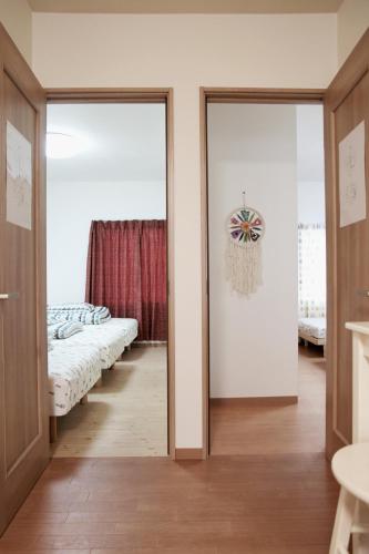 a bedroom with two beds and a mirror at Hachiken Chaya 2F 1-6ppl in Sapporo