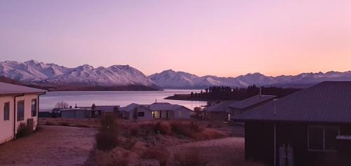 a view of a town with mountains and a body of water at Boujee in Lake Tekapo