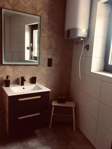a bathroom with a sink and a mirror at M2 in Złoty Stok