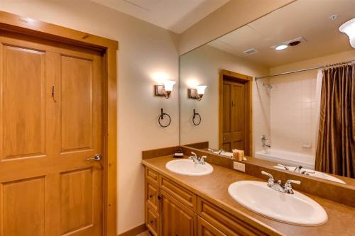 a bathroom with two sinks and a large mirror at 2 Bedroom Colorado Vacation Rental In River Run Village With Pool And Hot Tub Access in Keystone