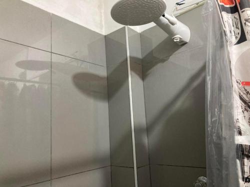 a shower with a shower head in a bathroom at ZAKAED HOME Airport in Lima