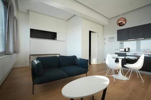 a living room with a couch and a table and chairs at Exclusive 1-bedroom apartment in Vienna