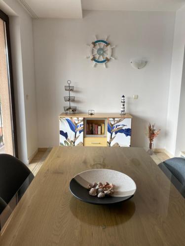 płyty siedzącej na drewnianym stole w obiekcie 59 Kaliakria Seaview Luxury Apartment w mieście Topola