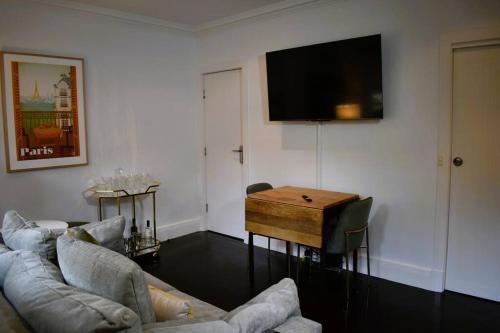 a living room with a couch and a table at East Melbourne 1BR - Close to the MCG in Melbourne