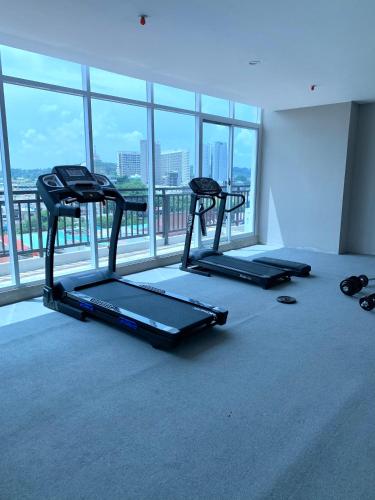 three treadmills in a room with a large window at Wiwi Formosa Residence Nagoya Batam in Nagoya