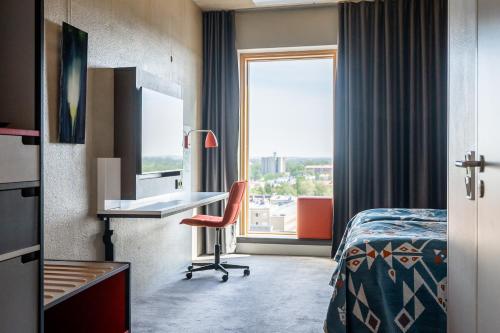 a hotel room with a bed and a window at Solo Sokos Hotel Torni Tampere in Tampere
