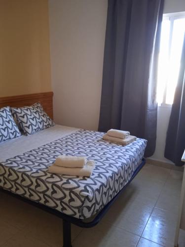a bedroom with a bed with two pillows on it at HOTEL El ALAMO MADRID in El Álamo