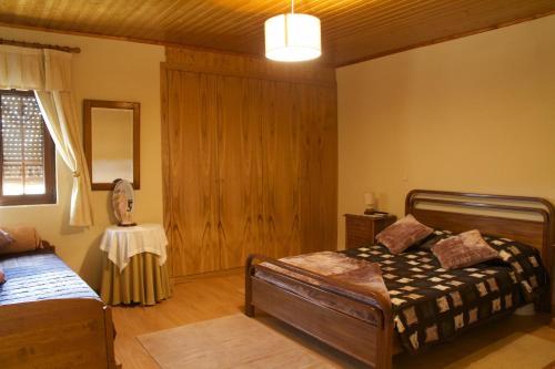 a bedroom with a bed and a table in it at Casarao dos Reis in Caravela